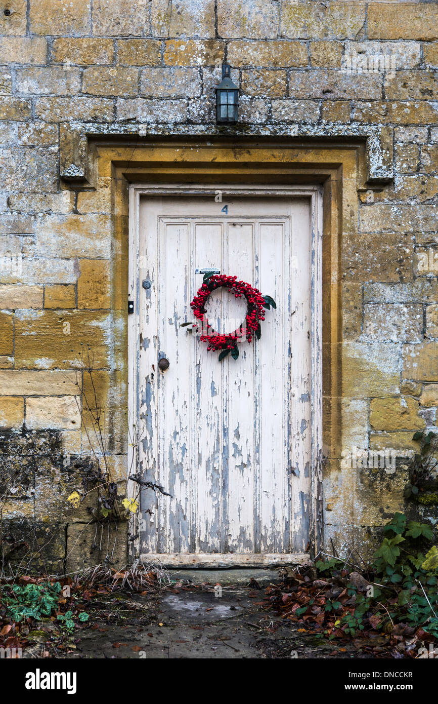 Historic Cotswold cottage with ring and peeling painted door
