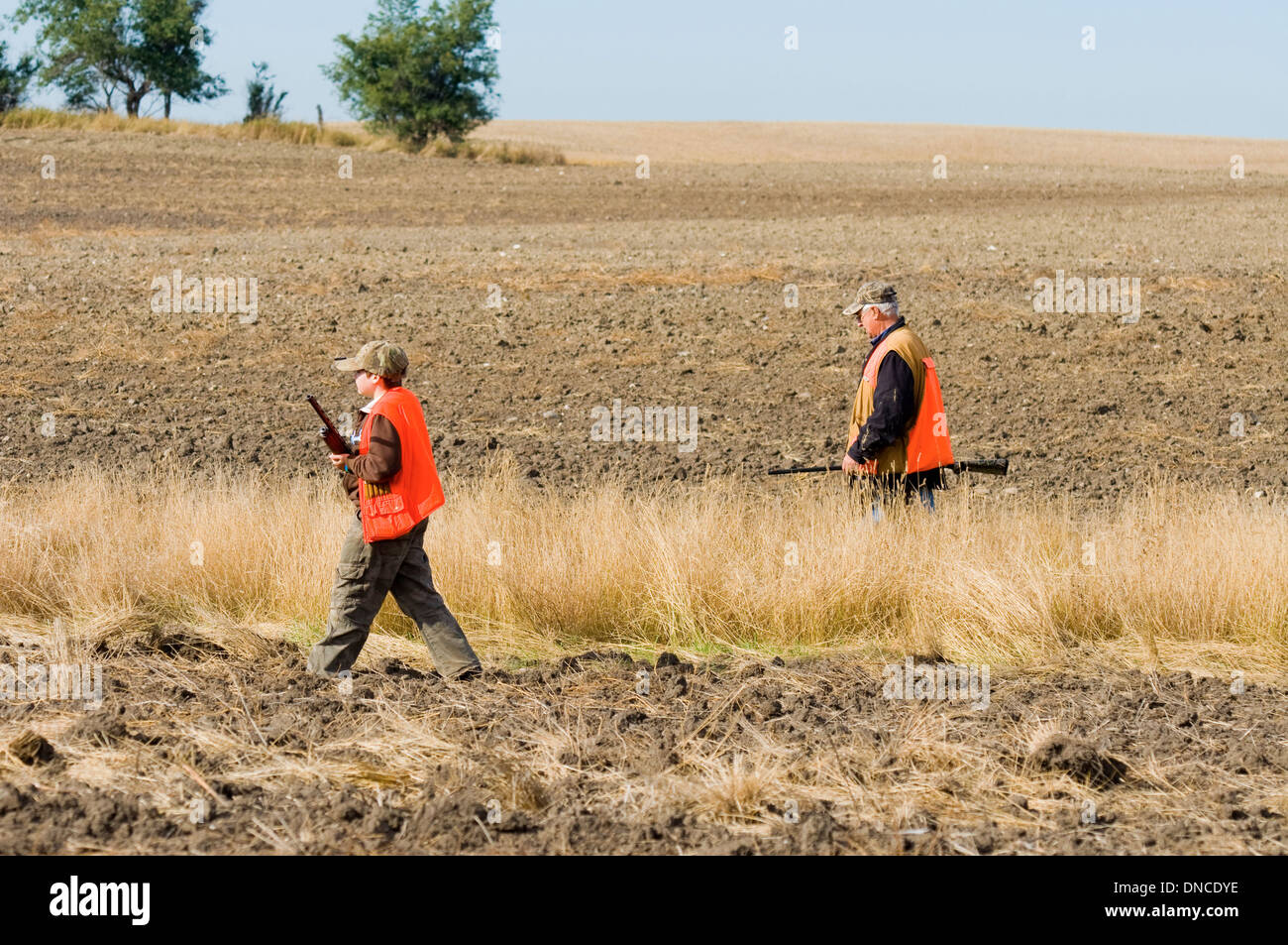 Hunters in field Stock Photo Alamy