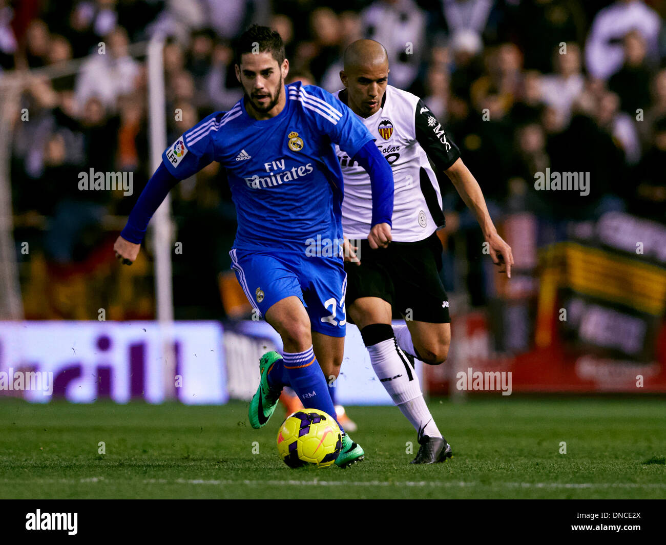 i22.12.2013 Valencia, Spain. Midfielder Isco of Real Madrid (L) is challenged by Midfielder Sofiane Feghouli of Valencia CF during the La Liga Game between Valencia and Real Madrid at Mestalla Stadium, Valencia Stock Photo