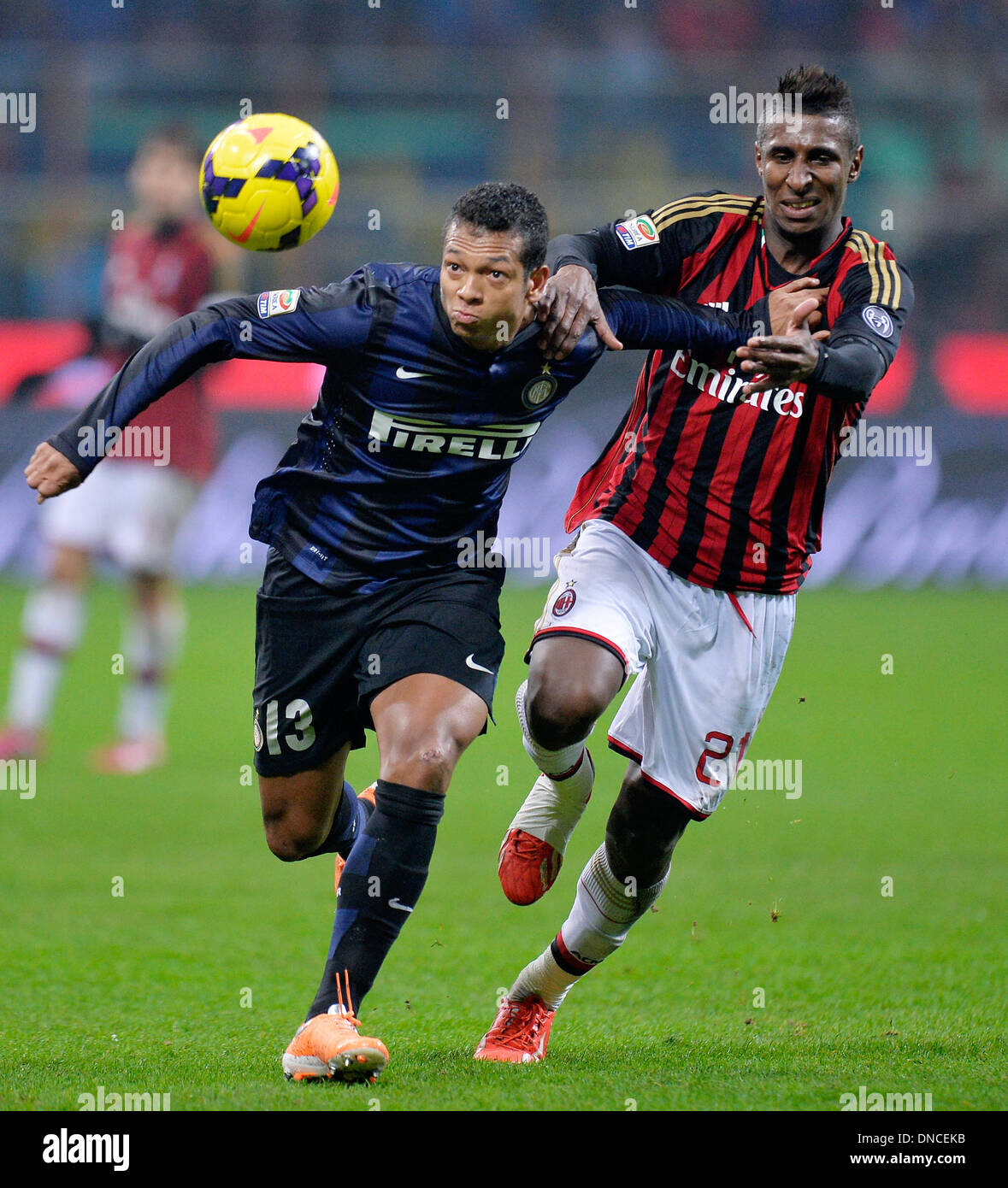 Milan, Italy. 23rd Dec, 2013. Inter Milan's Fredy Guarin (L) vies with AC Milan's Kevin Constant during their Italian Serie A soccer match in Milan, Italy, Dec. 22, 2013. Credit:  Alberto Lingria/Xinhua/Alamy Live News Stock Photo