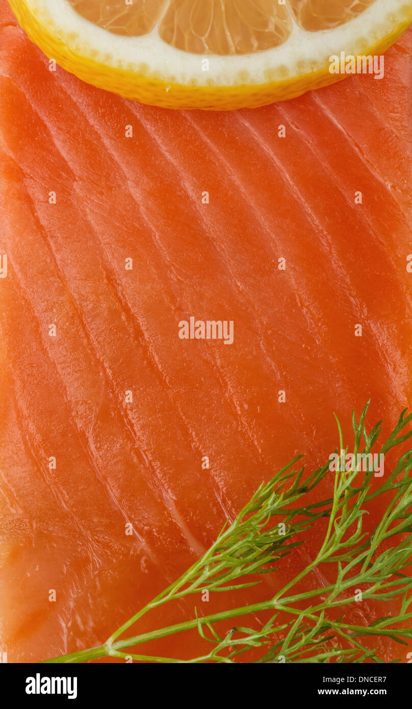 smoked red trout fillet served with lemon and dill Stock Photo