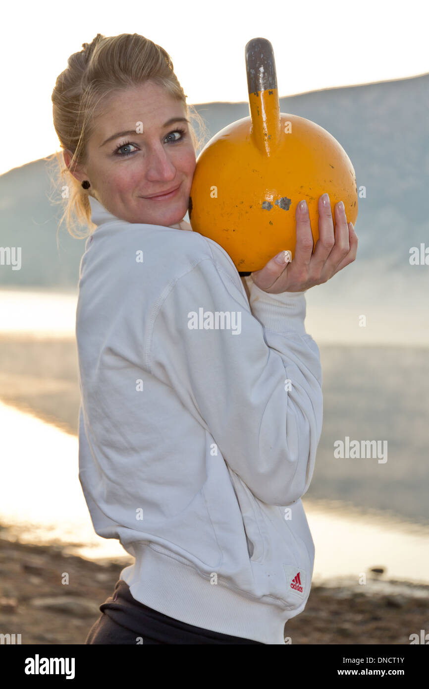 Picturesque early morning kettle-bell workout. Stock Photo