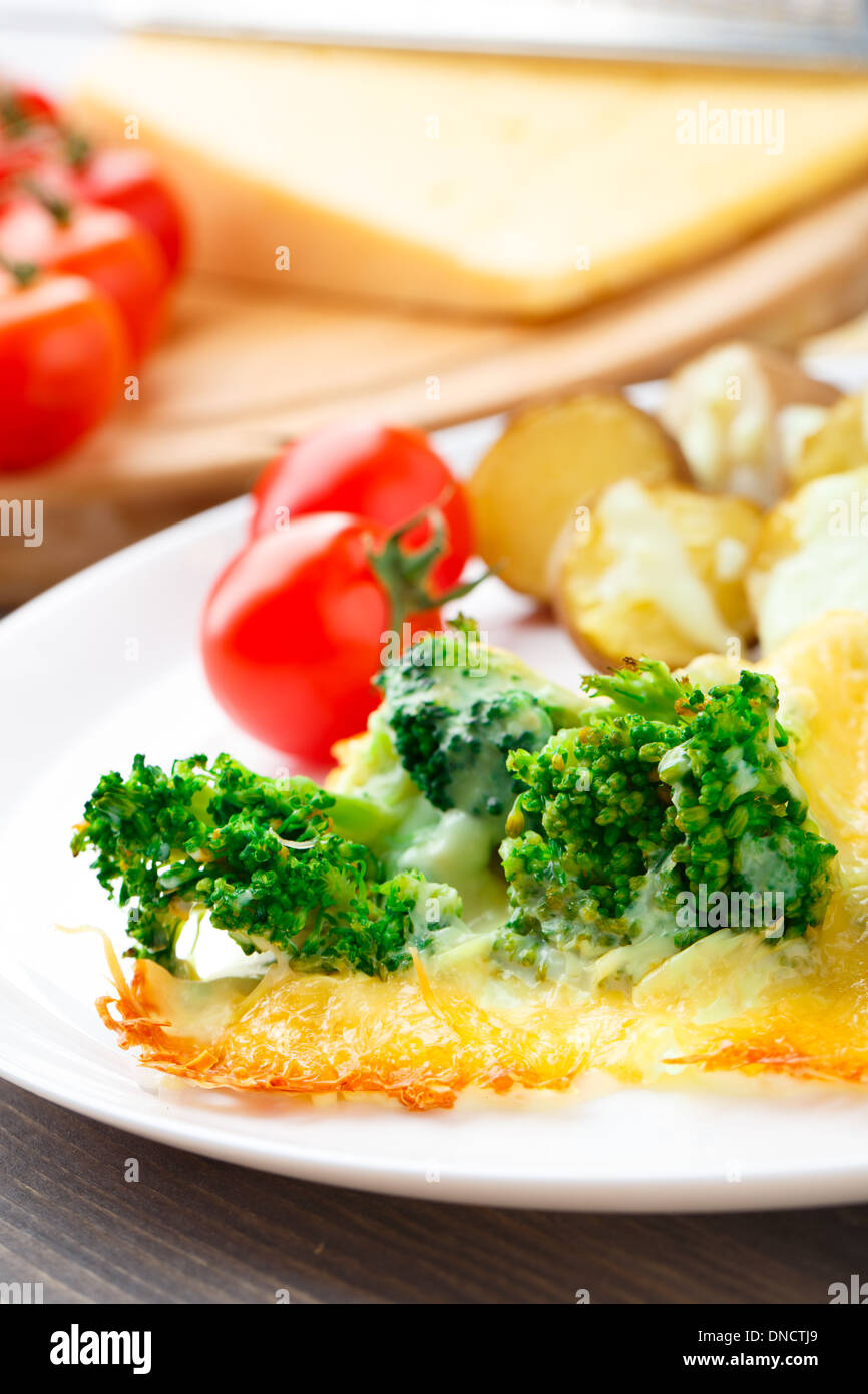 Broccoli gratin with cheese and baked potato Stock Photo Alamy