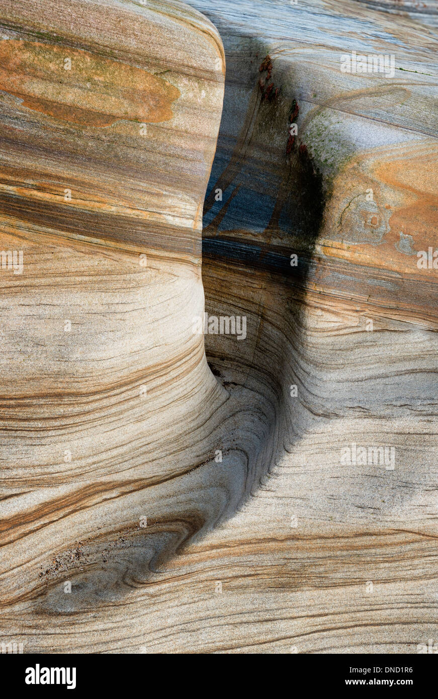 Colourful stratified carboniferous sedimentary rocks worn smooth by water. Stock Photo