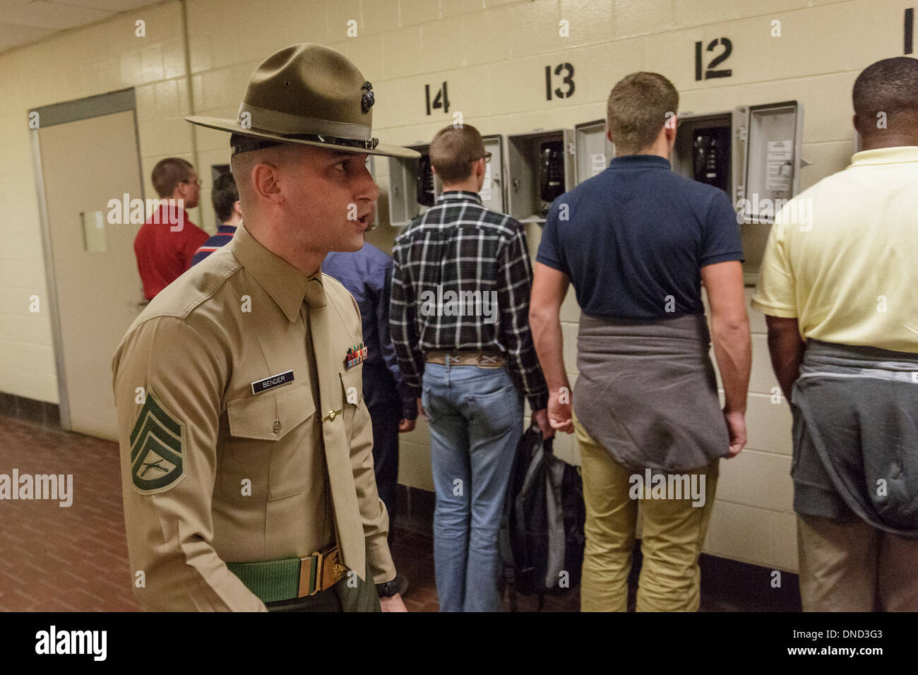 US Marine Corps Drill Instructors direct newly arrived recruits through the last call home during receiving at Marine Corps Recruit Depot Parris Island to begin 13 weeks of boot camp December 9, 2013 in Port Royal, South Carolina. The Marines train about 17,000 recruits at Parris Island yearly. Stock Photo