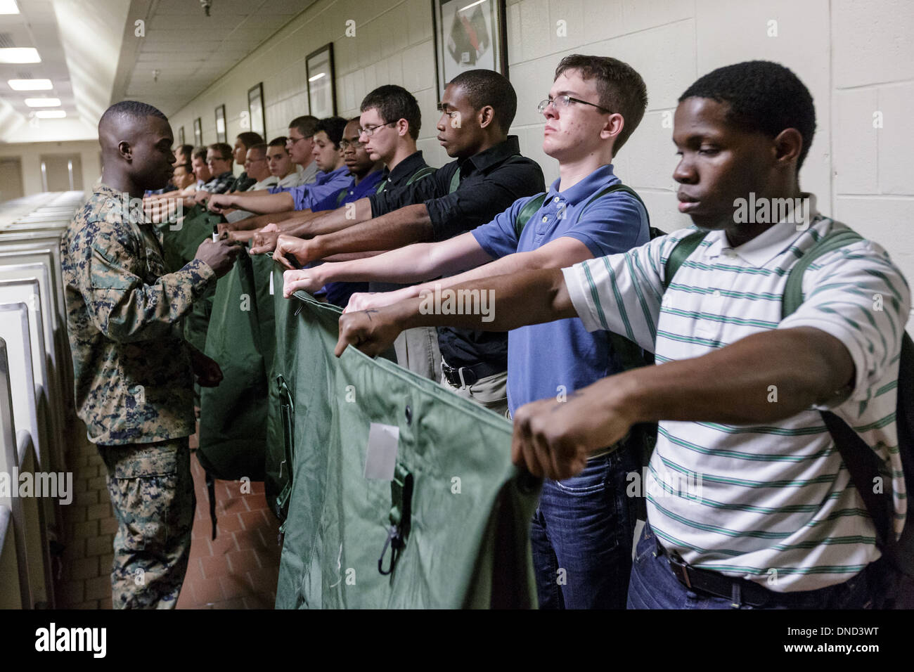 A US Marine watches over newly arrived recruits as they are issued