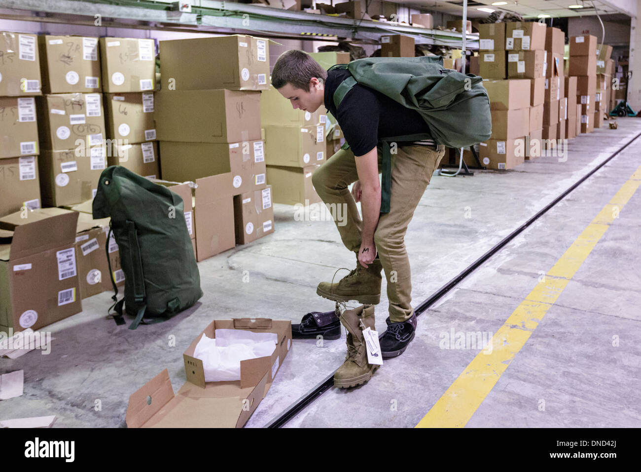 Newly arrived Marine Corps recruits are issued their equipment during receiving at Marine Corps Recruit Depot Parris Island beginning 13 weeks of boot camp December 9, 2013 in Port Royal, South Carolina. The Marines train about 17,000 recruits at Parris Island yearly. Stock Photo