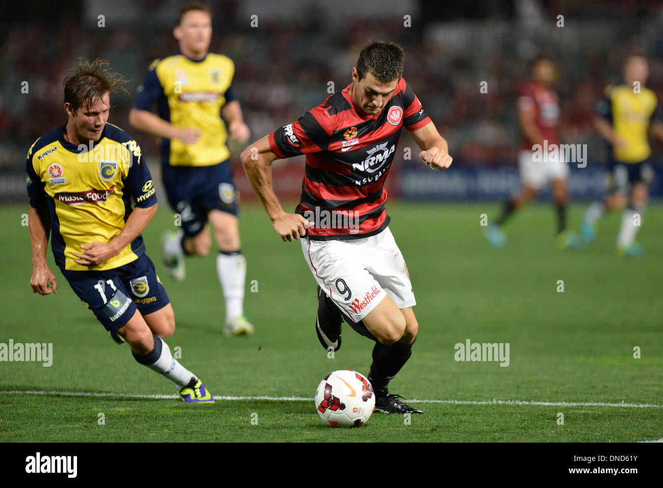 Sydney, Australia. 23rd Dec, 2013. Mariners forward Nicholas Fitzgerald and Wanderers forward Tomi Juric in action during the Hyundai A League game between Western Sydney Wanderers FC and Central Coast Mariners FC from the Pirtek Stadium, Parramatta. The Wanderers won 2-0. Credit:  Action Plus Sports/Alamy Live News Stock Photo