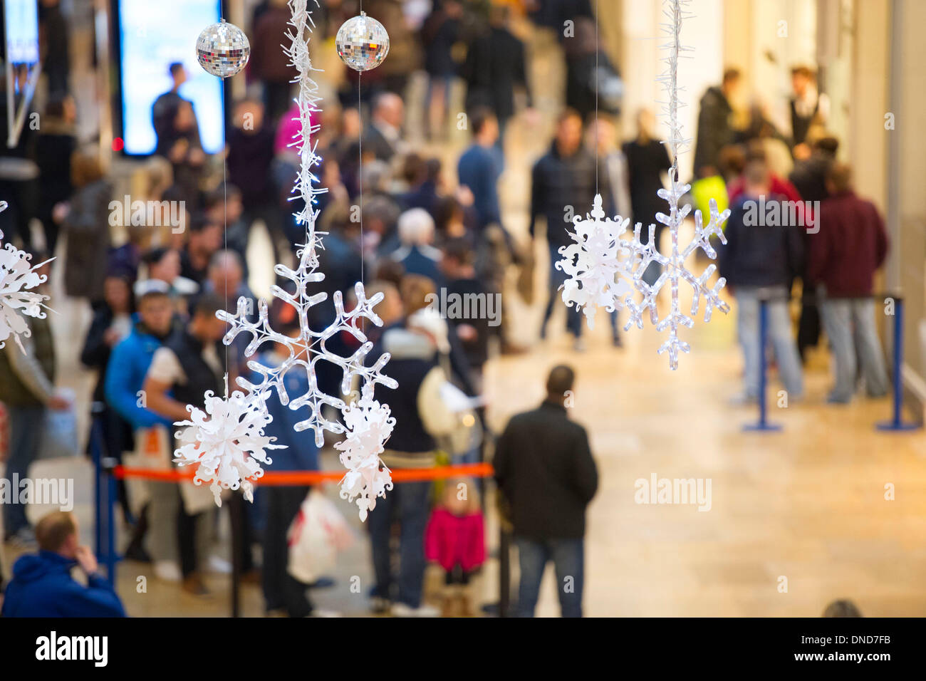 Cardiff, Wales, UK. December 23. Christmas shoppers brave bad weather on Mega Monday to go shopping for last minute presents on December 23 in St David's Arcade, Cardiff, Wales. Shoppers are expected to spend £12 billion in four days. Some shops have already started their sales. (Photo by Matthew Horwood/Alamy Live News) Stock Photo