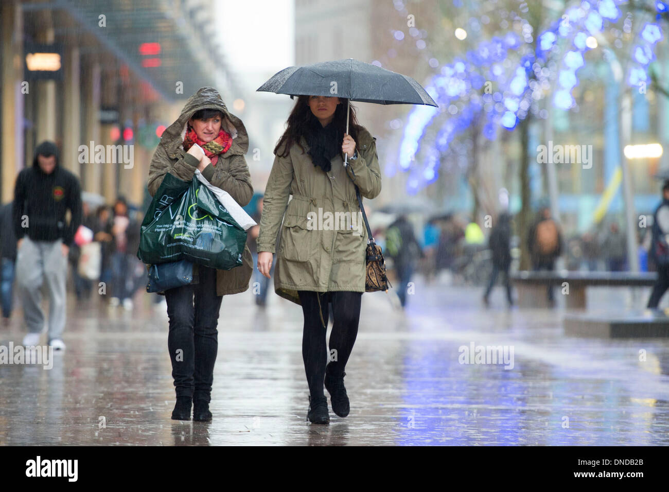 Cardiff, Wales, UK. December 23. Christmas shoppers brave bad weather on Mega Monday to go shopping for last minute presents on December 23 Cardiff, Wales. Shoppers are expected to spend £12 billion in four days. Some shops have already started their sales. (Photo by Matthew Horwood/Alamy Live News) Stock Photo