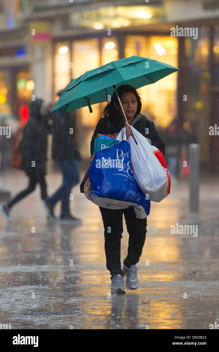 Cardiff, Wales, UK. December 23. Christmas shoppers brave bad weather on Mega Monday to go shopping for last minute presents on December 23 Cardiff, Wales. Shoppers are expected to spend £12 billion in four days. Some shops have already started their sales. (Photo by Matthew Horwood/Alamy Live News) Stock Photo