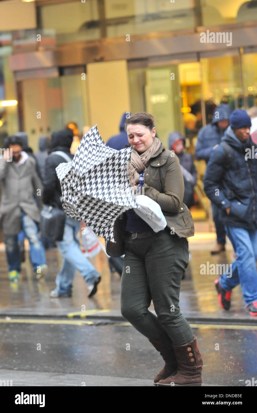 Regent Street, London, UK. 23rd December 2013. Wind and rain start to hit shoppers in central London.  Forecasters warned of widespread disruption as the stormy weather passed over the UK. Credit:  Matthew Chattle/Alamy Live News Stock Photo