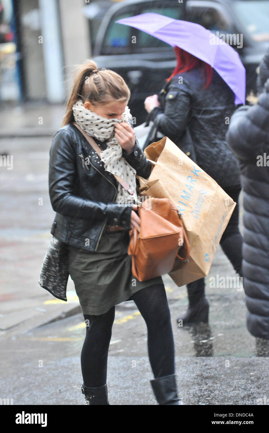 Regent Street, London, UK. 23rd December 2013. Wind and rain start to hit shoppers in central London.  Forecasters warned of widespread disruption as the stormy weather passed over the UK. Credit:  Matthew Chattle/Alamy Live News Stock Photo