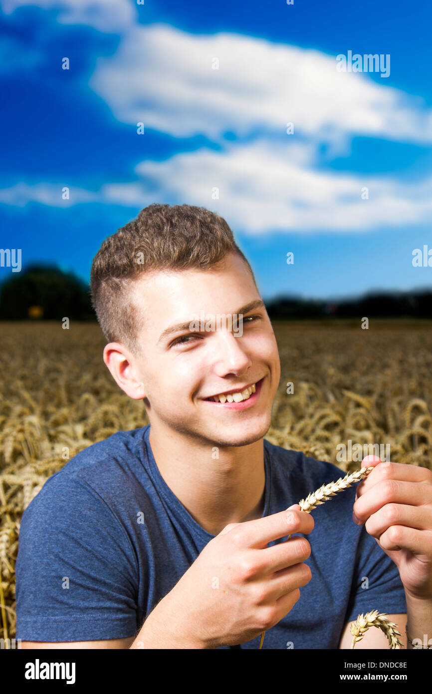 Young farmer looking at the return bringing harvest Stock Photo