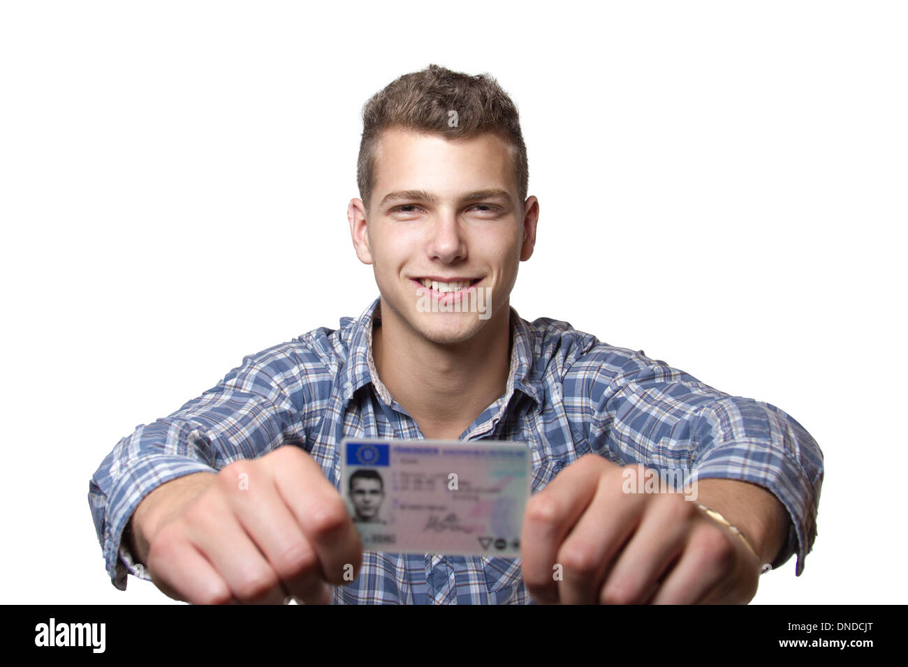 Young man just recieved his drivers license and is happy to drive his own car soon Stock Photo