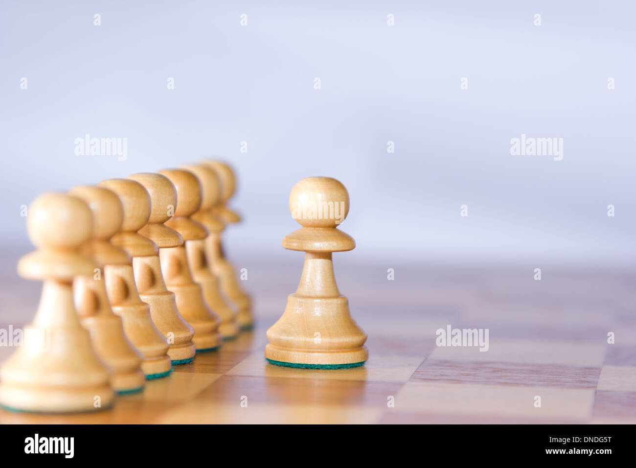 Outstanding chess pawn on the right is focused Stock Photo