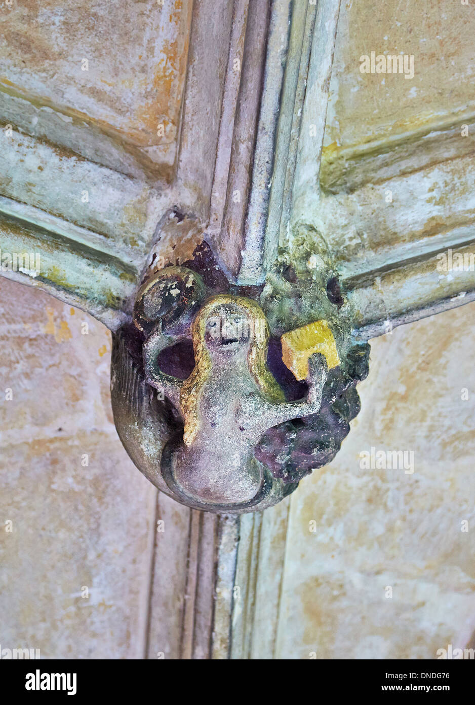 Ceiling boss in the form of a painted mermaid with mirror and golden box in the cloisters of Lacock Abbey in Wiltshire Stock Photo