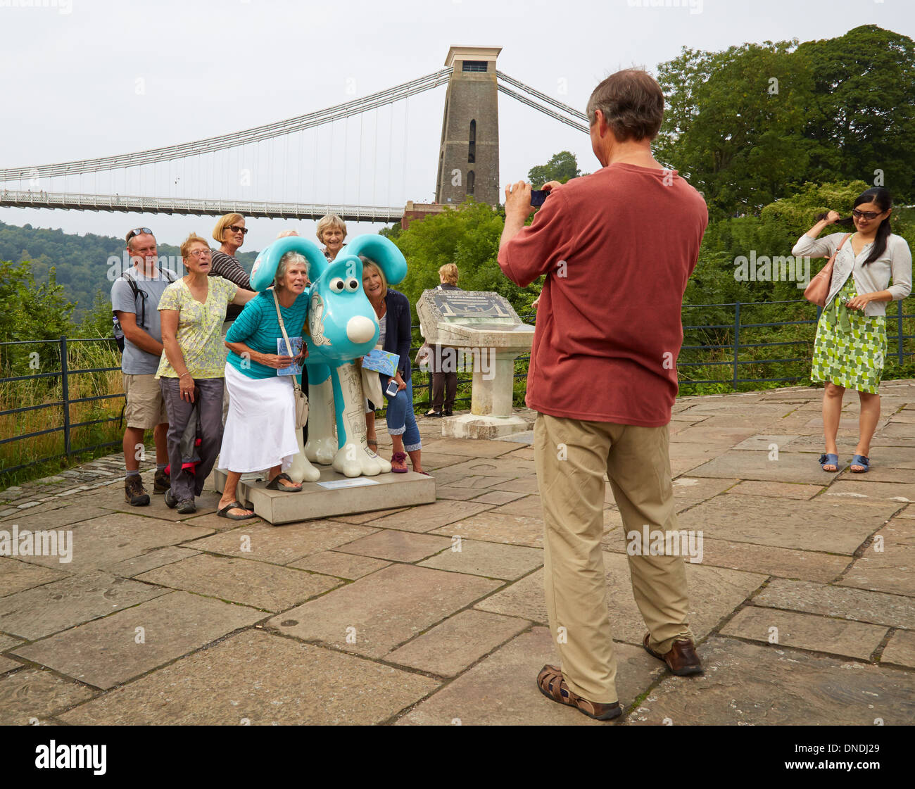 Bristol Gromit Trail 2013 - a photographer snaps a group of mature friends by the Clifton Suspension Bridge viewpoint Stock Photo
