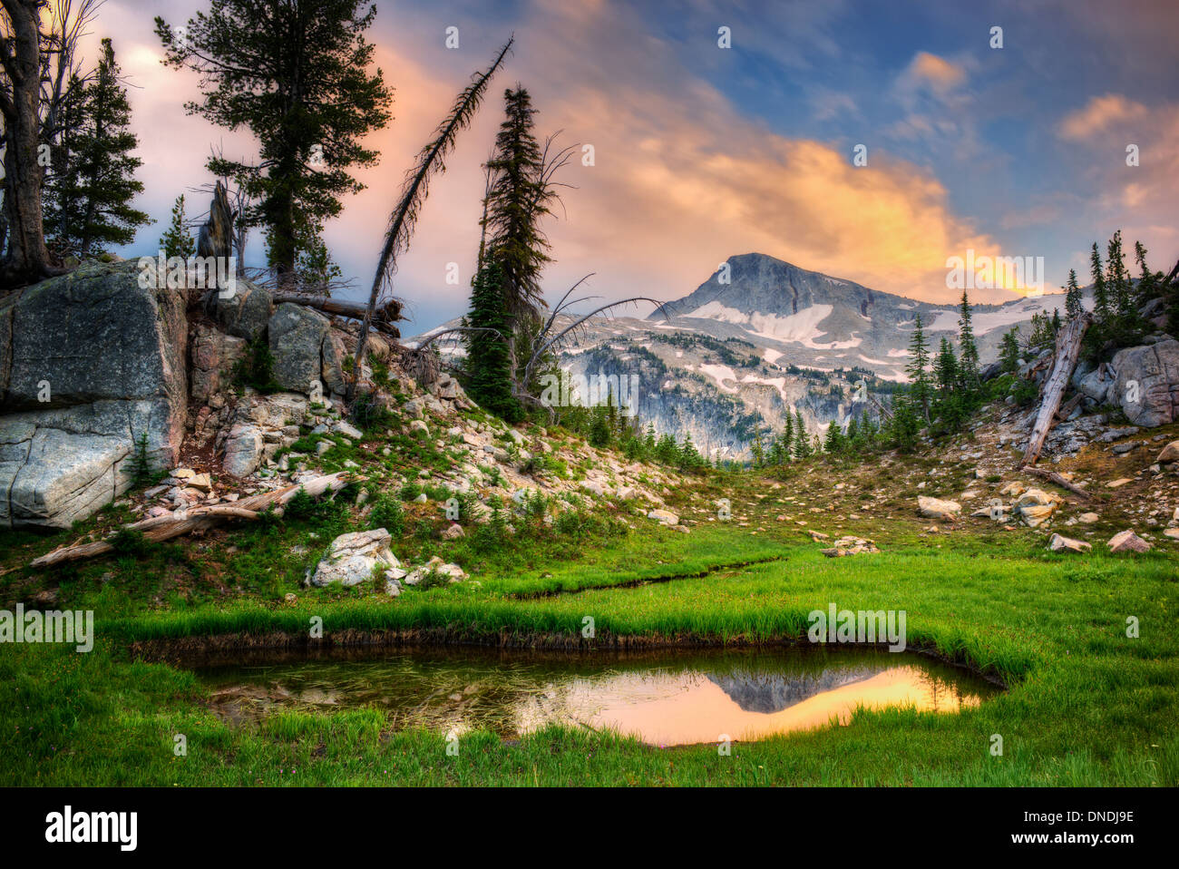 Small pond reflecting Eagle Cap Mountain and sunset clouds. Eagle Cap wilderness, Oregon Stock Photo