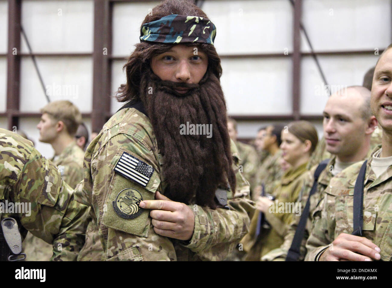 A US Army soldier wearing a fake beard waits for Duck Dynasty reality television star Willie Robertson December 9, 2013 at Bagram Airfield, Parwan province, Afghanistan. The visit was part of the USO Holiday Tour. Stock Photo