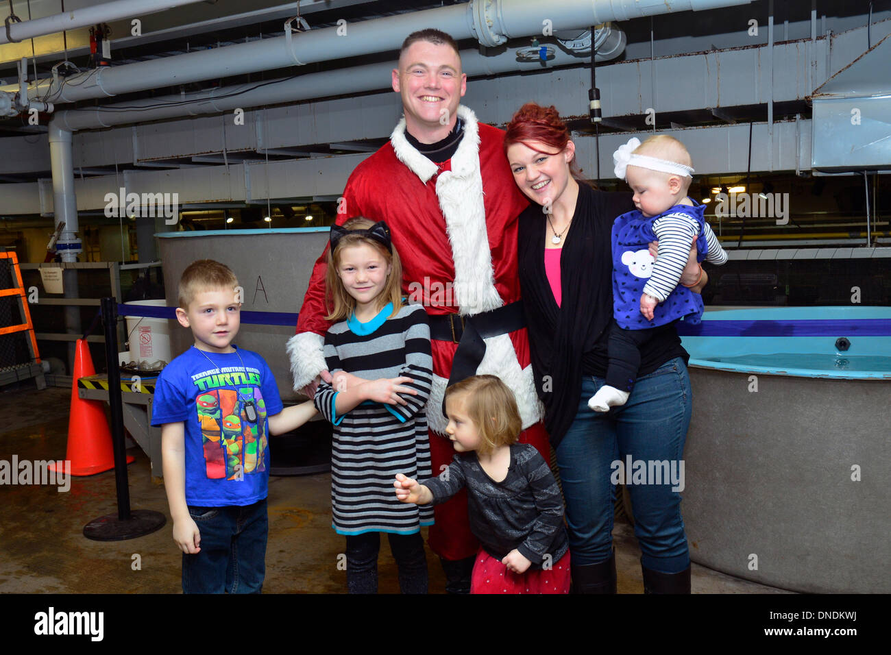 US Army First Lt. Nick Aldridge poses with his family as Scuba Claus at the Mall of America's Sea Life Aquarium after returning to the United States from a deployment to Afghanistan December 22, 2013 in Bloomington, MN. Stock Photo