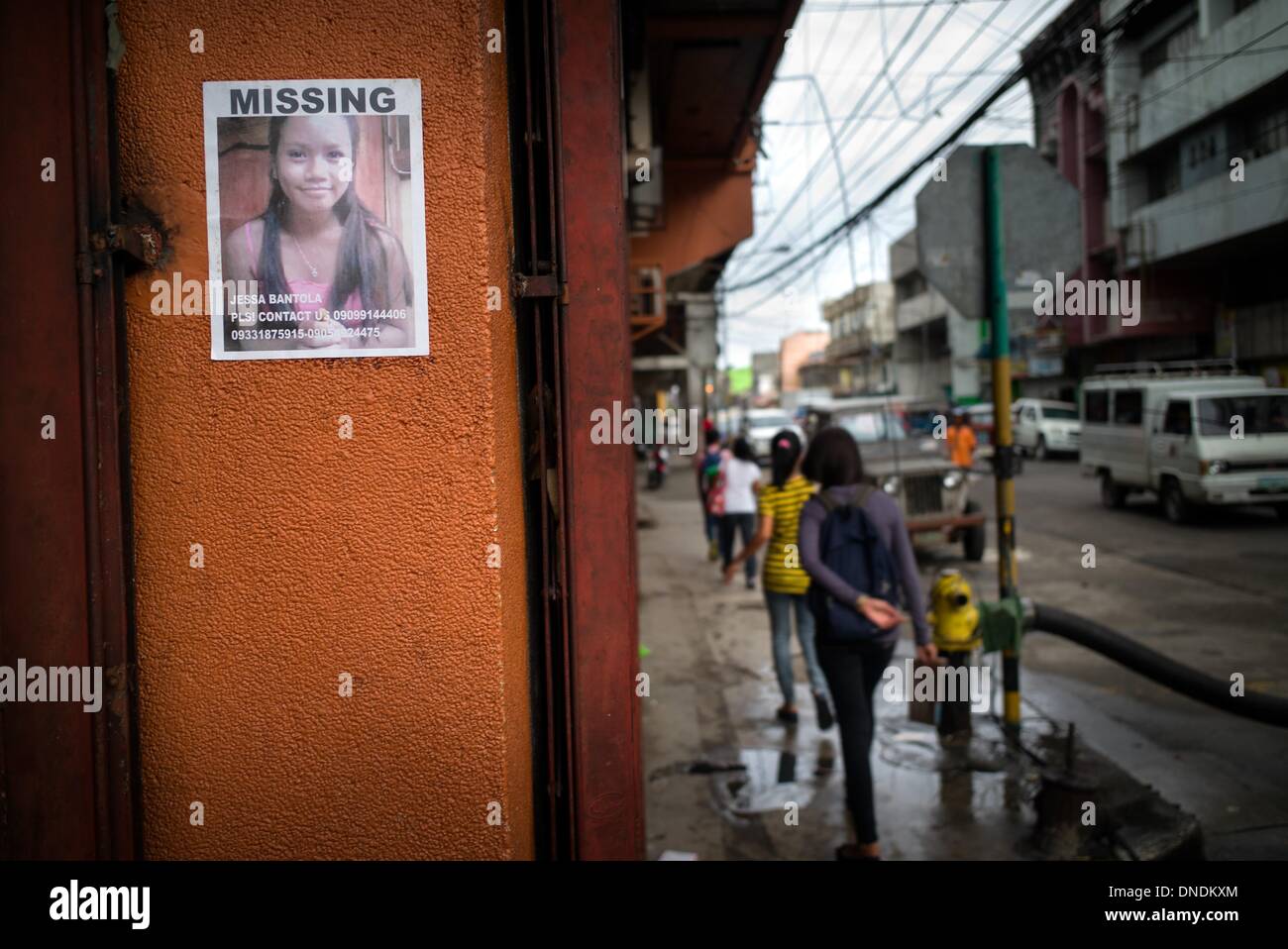 Tacloban, Leyete, Philippines. 23rd Dec, 2013. A poster of a missing person is pasted on the walls of the local shop downtown Tacloban.One of the most ferocious typhoons to hit the Philippines, Haiyan left more than 6,000 people dead and nearly 1,800 others missing. It damaged or swept away more than 1.1m houses and injured more than 27,000 people.More than 4 million people were displaced, with about 101,000 remaining in 300 emergency shelters in central provinces. Credit:  Agron Dragaj/ZUMAPRESS.com/Alamy Live News Stock Photo