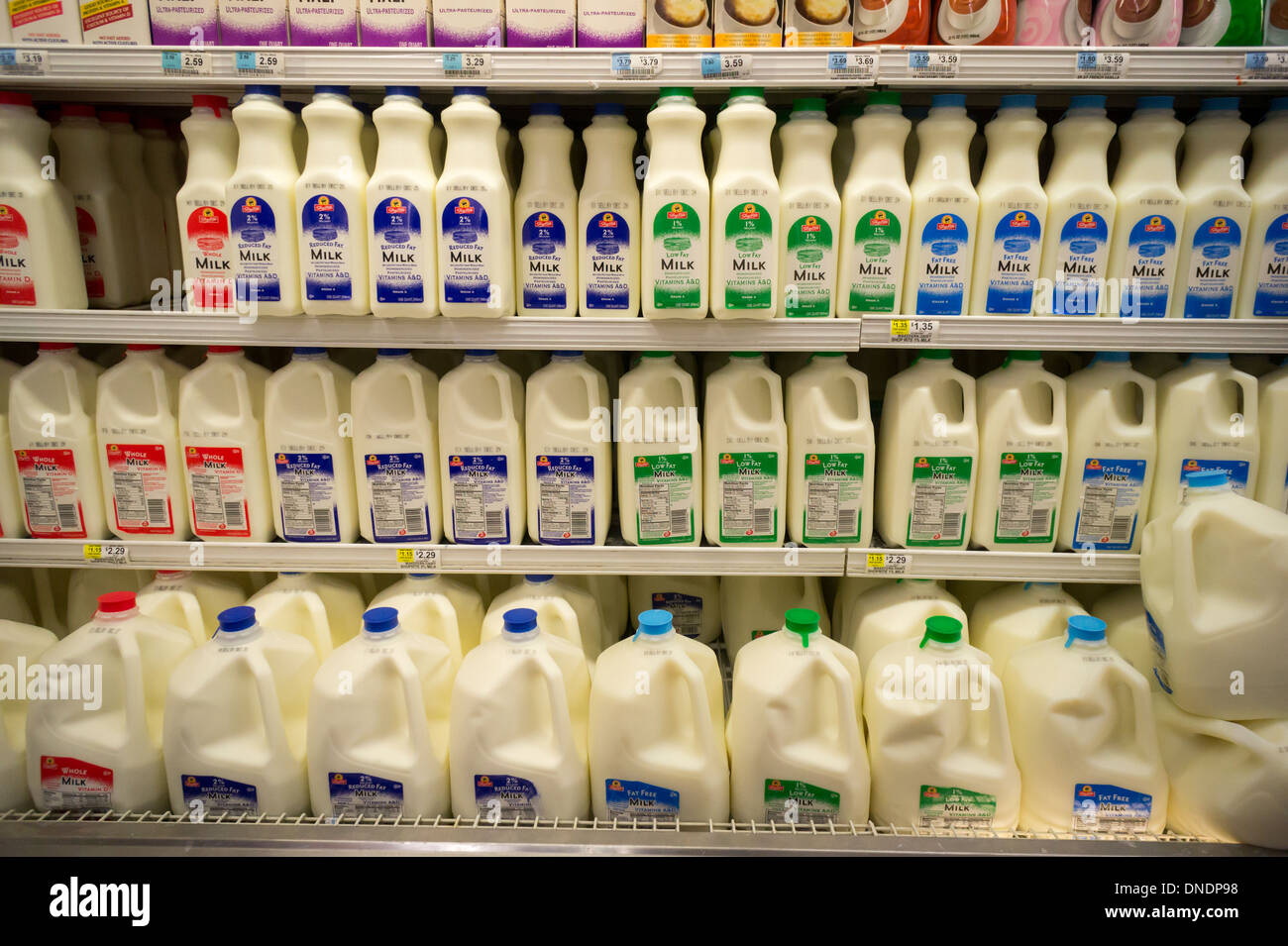 Containers of milk in a supermarket refrigerator in New York Stock