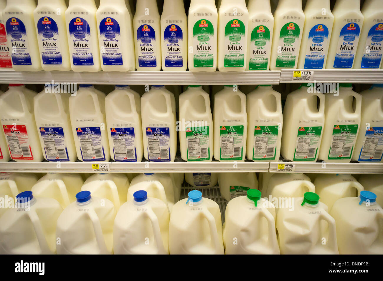 Containers of milk in a supermarket refrigerator in New York Stock