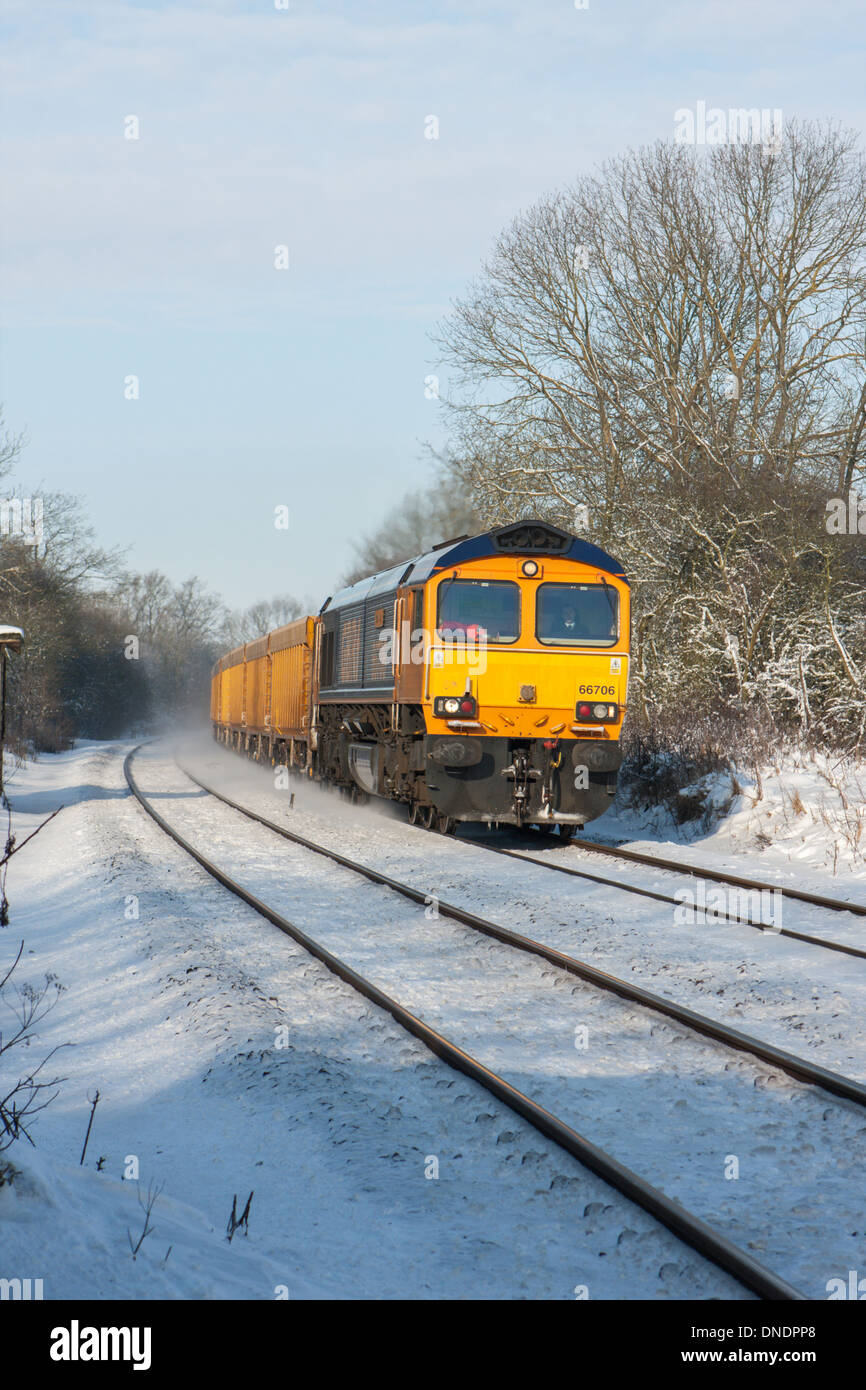 GBRf Class 66 diesel freight locomotive traveling through snow between Melton Mowbray Leicestershire and Oakham Rutland UK Stock Photo