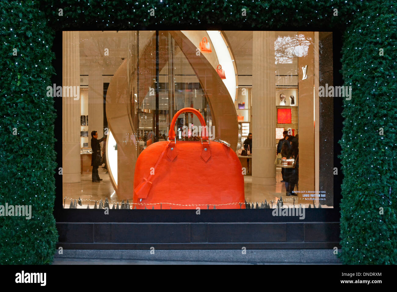 Christmas shop window display with Louis Vuitton Townhouse section & lift inside Selfridges department store seen from pavement Stock Photo