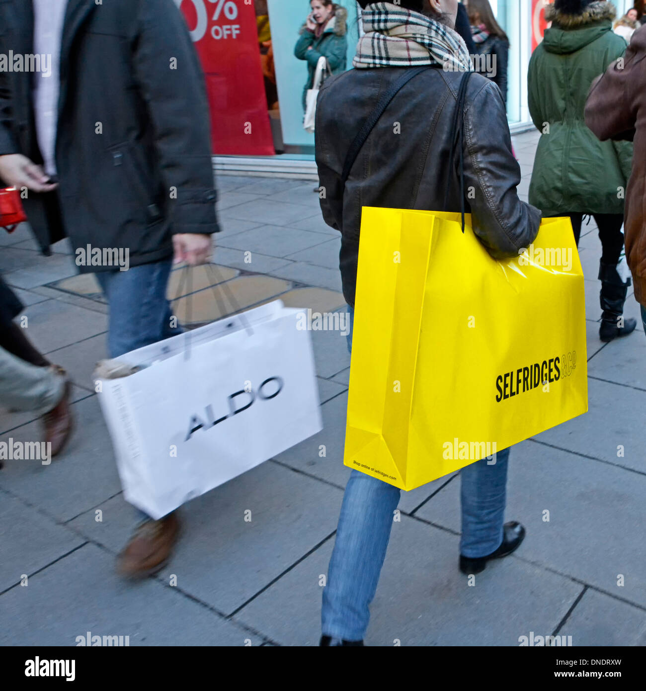 Shoppers with carrier bags from Selfridges and Aldo stores in Oxford Street Stock Photo