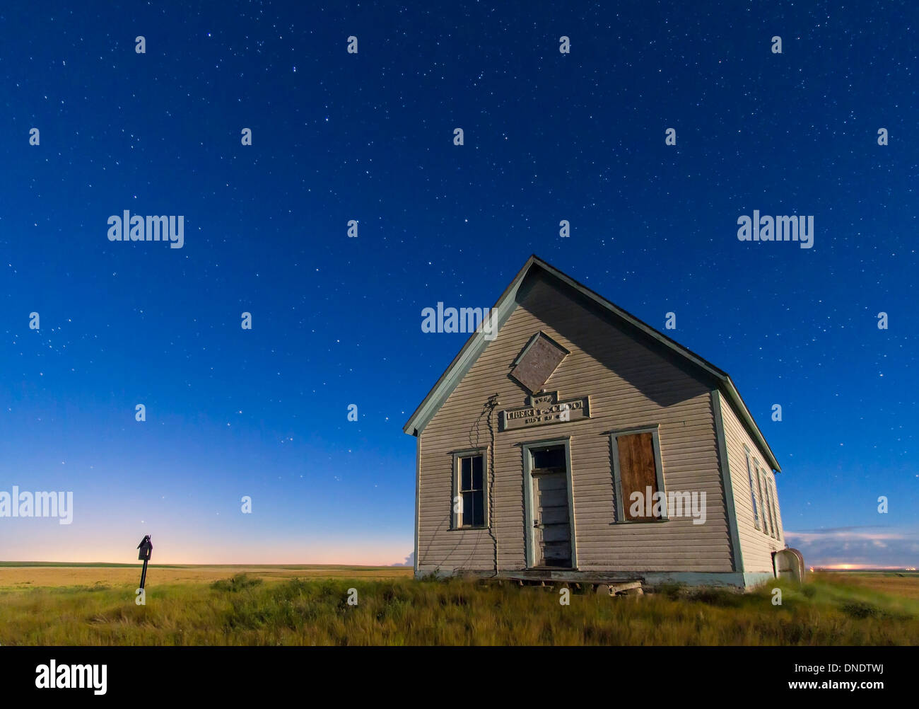 The 1909 Liberty School on the Canadian Prarie in moonlight with Big Dipper. Stock Photo