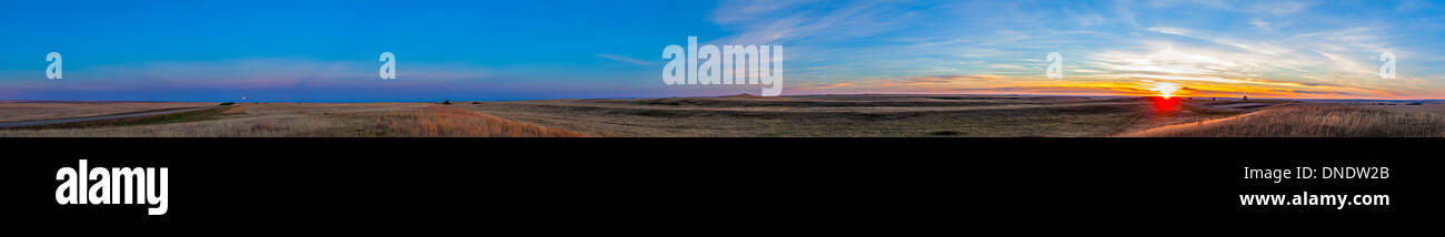 Panoramic view of the rising harvest moon and setting Sun, Alberta, Canada. Stock Photo