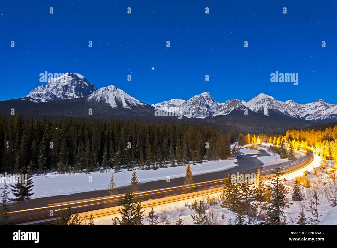 A moonlit nightscape over the Bow River and Morant's Curve in Banff National Park, Canada. Stock Photo