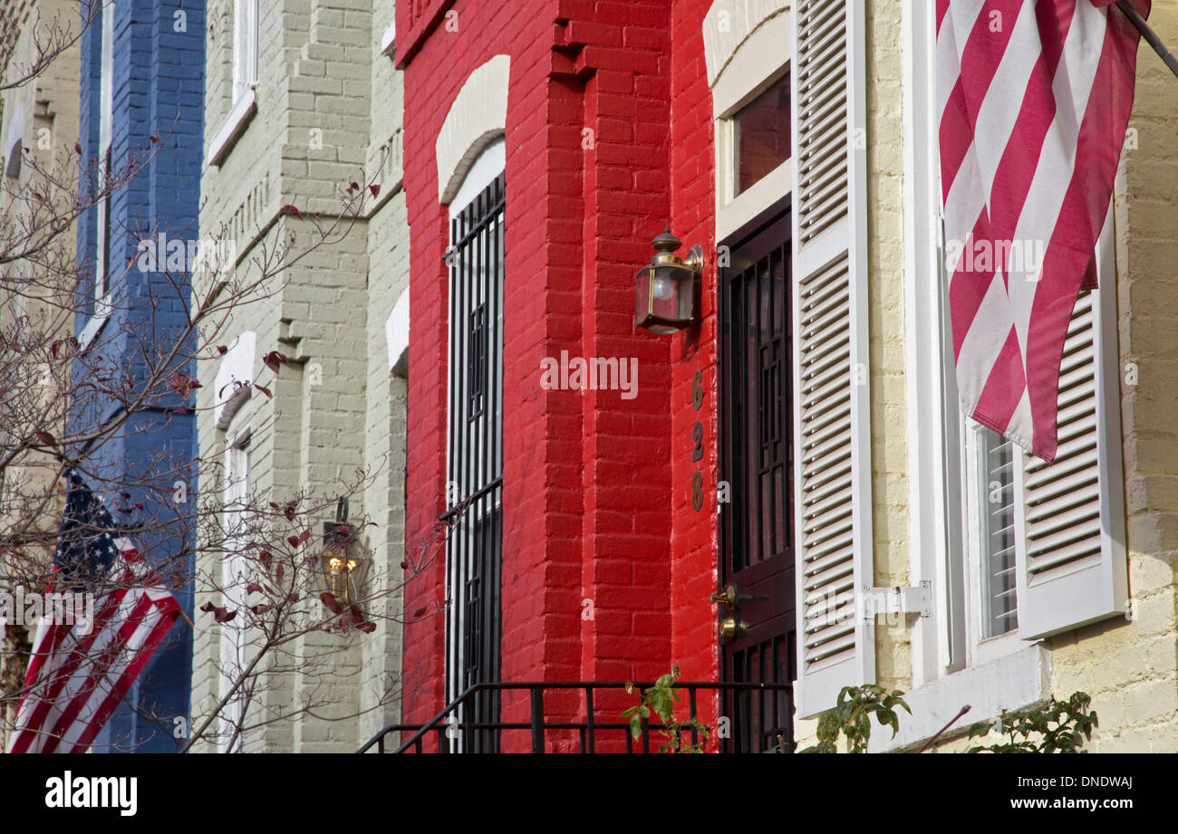 Washington, DC - Row houses painted red, white, and blue with American flags on Capitol Hill. Stock Photo