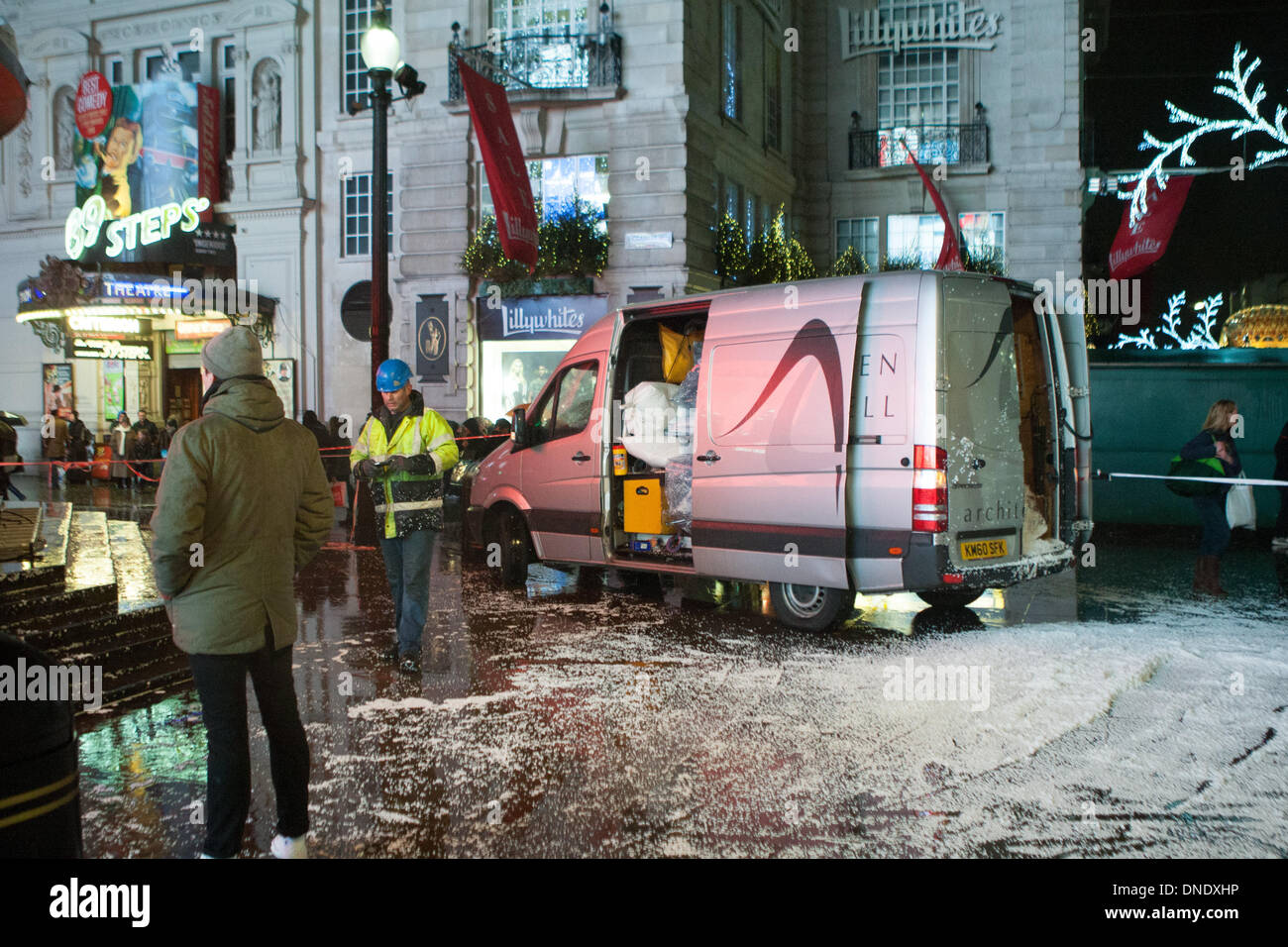 London, UK. 23rd Dec, 2013. Giant snow globe around Eros in Piccadilly Circus in London deflates because of the high winds. The stormy weather has caused disruption across the UK. Credit:  martyn wheatley/Alamy Live News Stock Photo