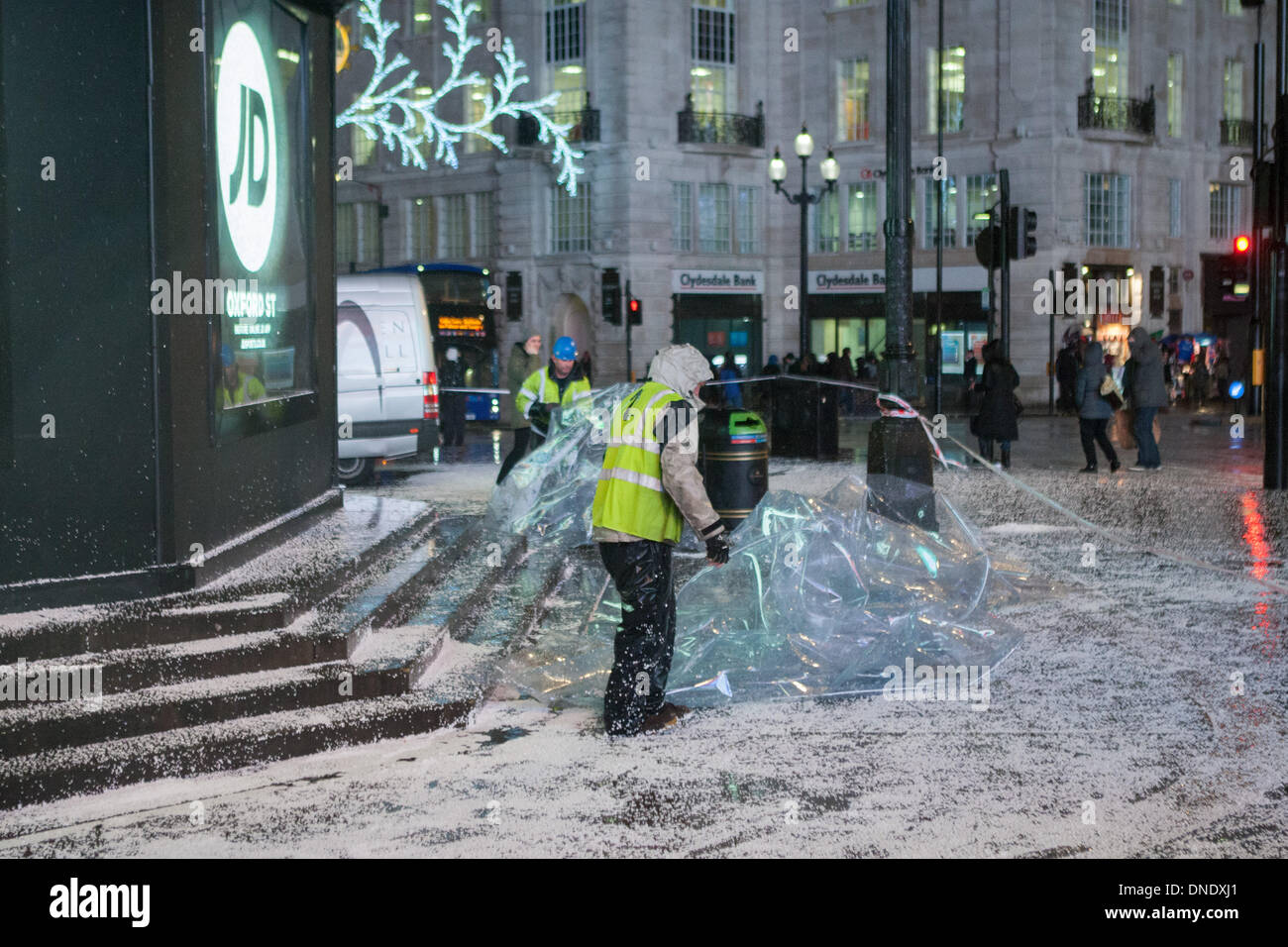 London, UK. 23rd Dec, 2013. Giant snow globe around Eros in Piccadilly Circus in London deflates because of the high winds. The stormy weather has caused disruption across the UK. Credit:  martyn wheatley/Alamy Live News Stock Photo