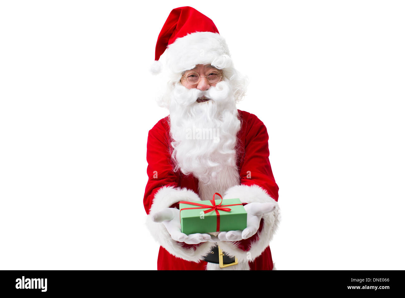 Santa Claus handing out Christmas gift Stock Photo - Alamy