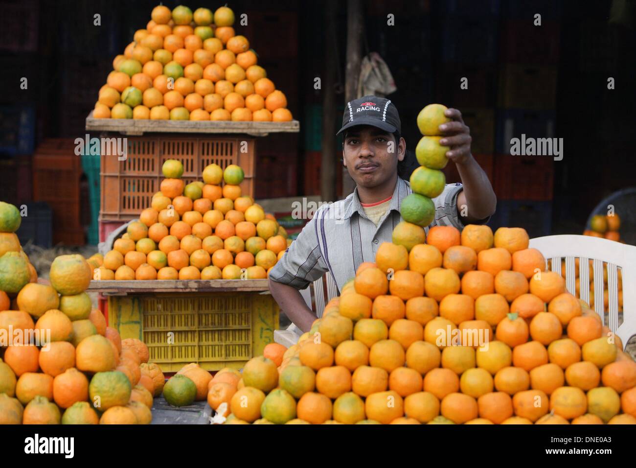 Nagpur, India. 23rd Dec, 2013. A shopkeeper sells oranges at a fruit market in Nagpur, which is