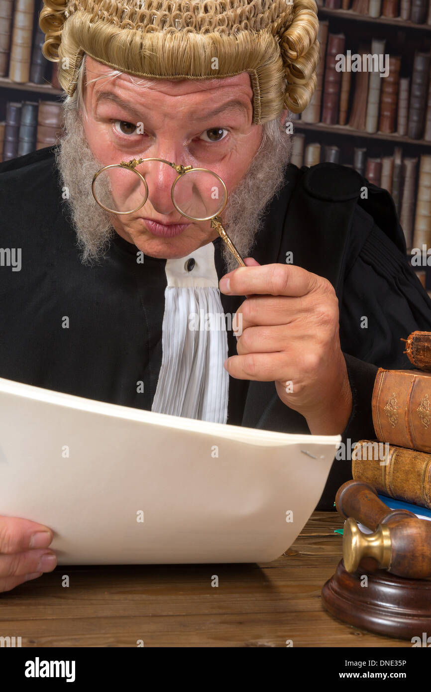 Funny old judge looking through a lorgnette Stock Photo