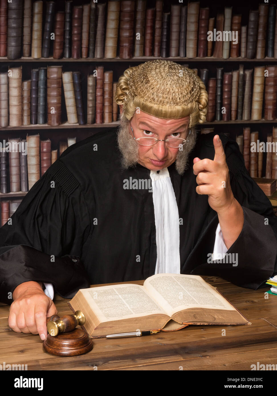 Judge with wig and gavel holding a speech to the convicted criminal Stock Photo