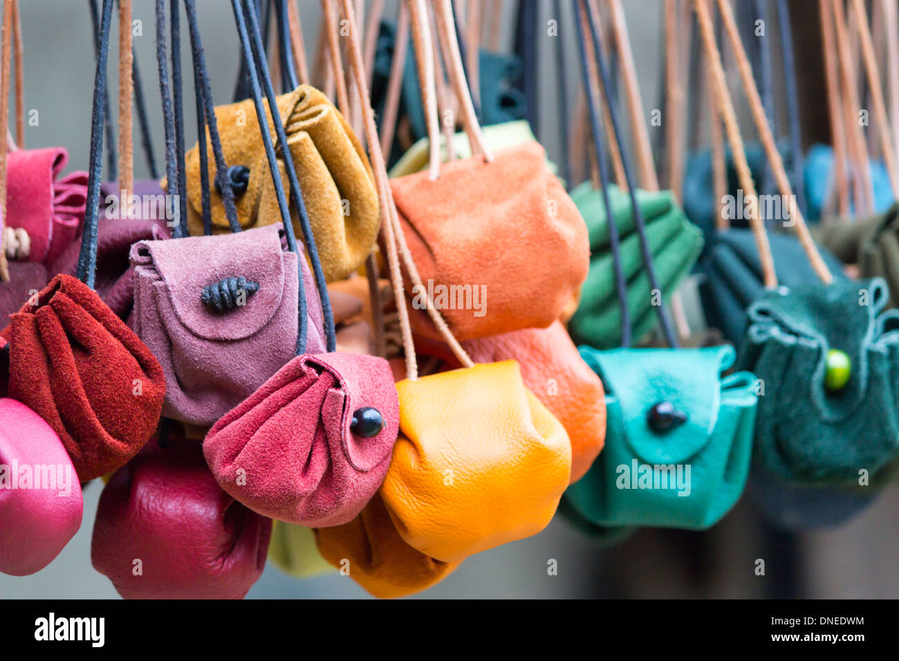Colored leather moneybags hanging at laces Stock Photo