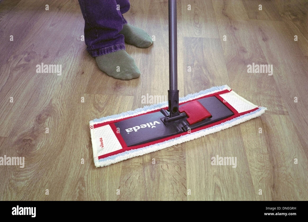 Man Using a Vileda Mop on a Vinyl Wood Effect Floor, UK MODEL RELEASED Stock Photo