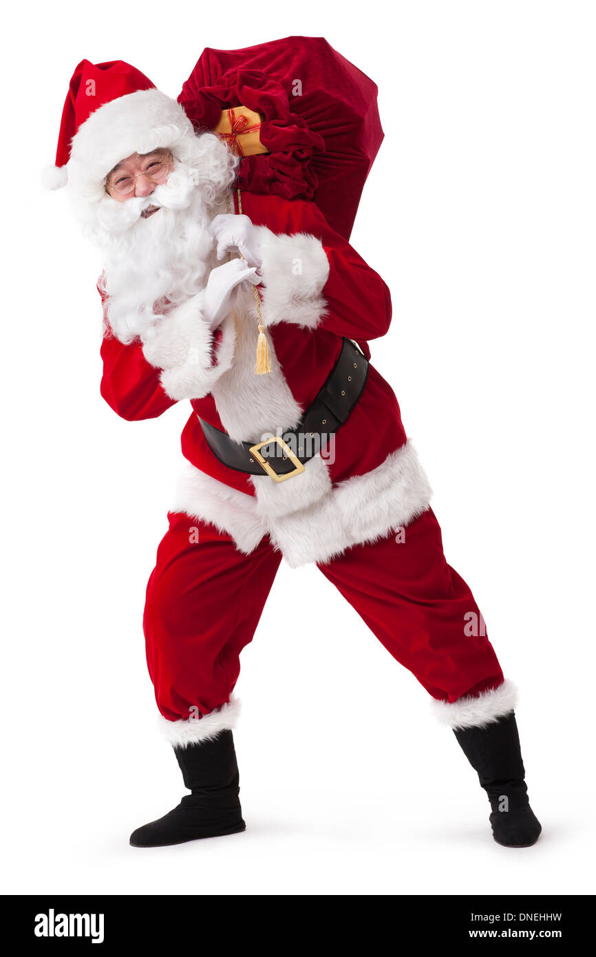 Santa Claus carrying sack of gifts Stock Photo - Alamy