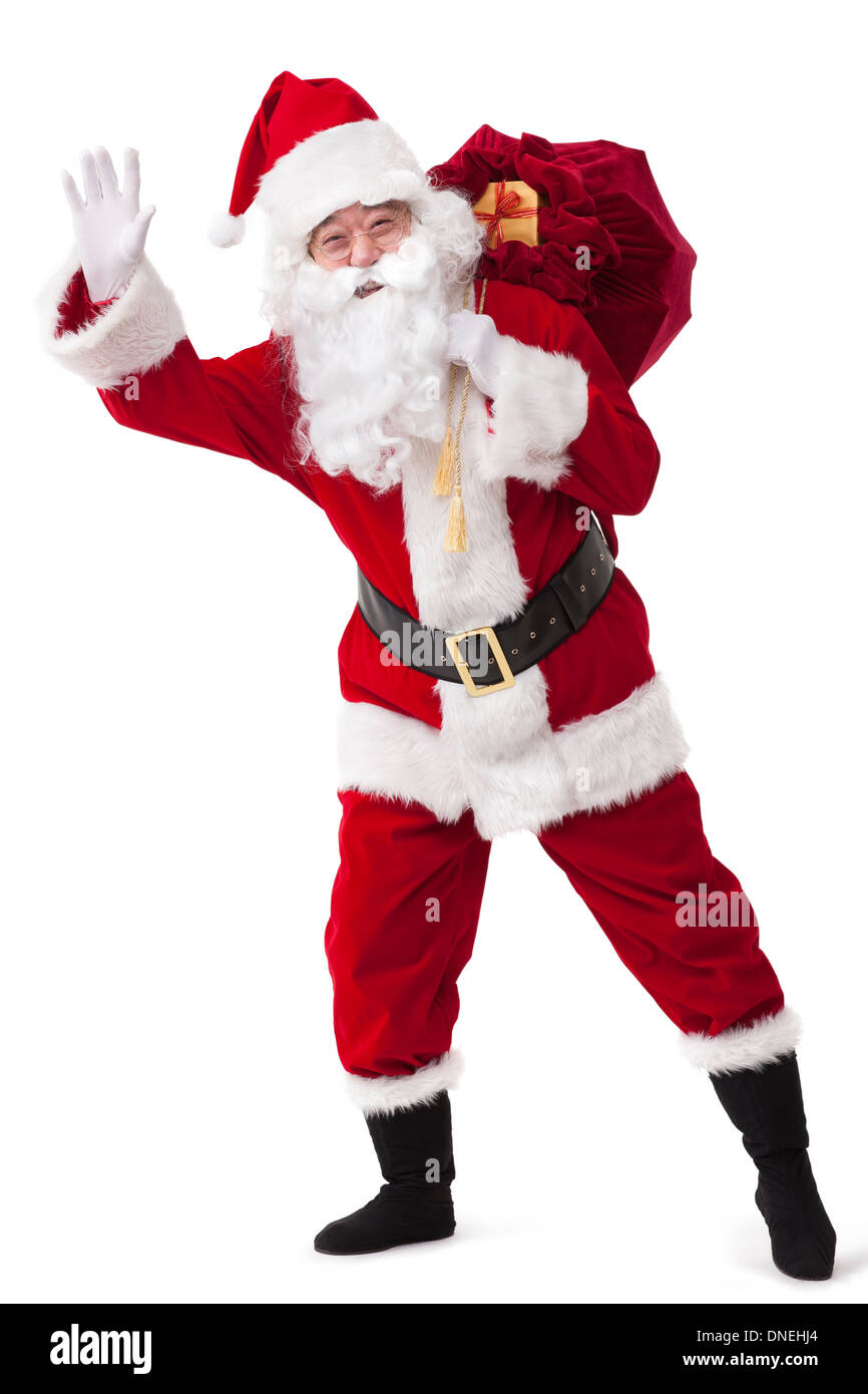 Santa Claus carrying sack of gifts and waving Stock Photo - Alamy