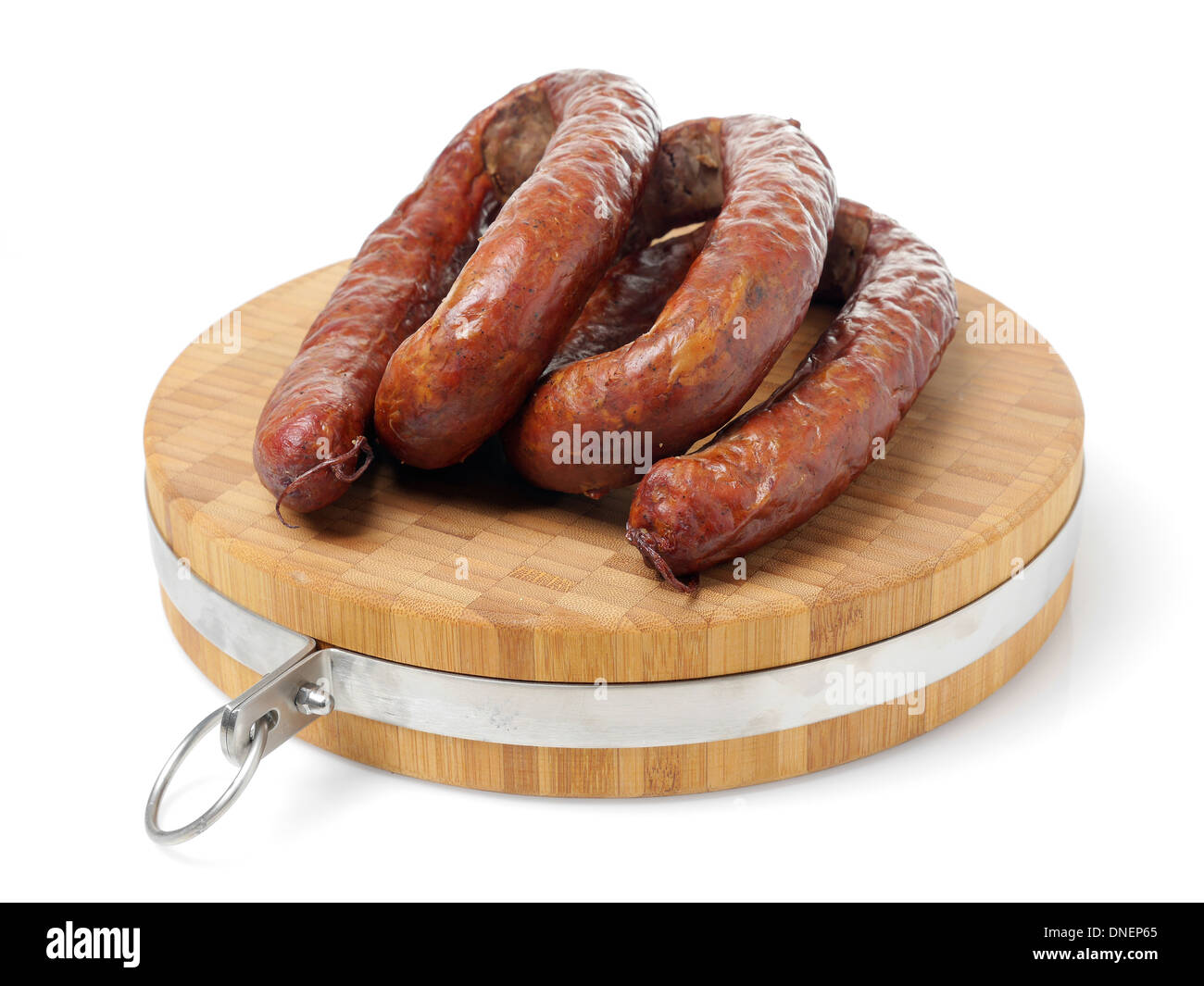 Polish sausage loops on cutting board over white background Stock Photo