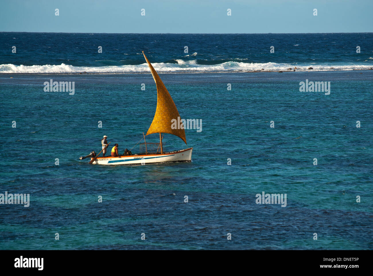 Local fishermen sailing small boat inside reef, Mauritius Stock Photo