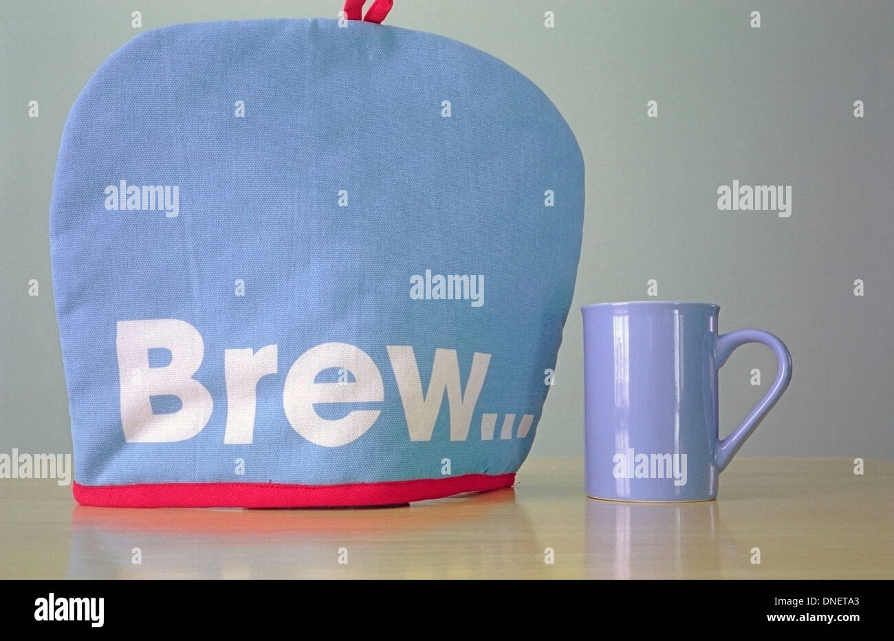 Tea Cosy and Blue Mug Stock Photo Alamy