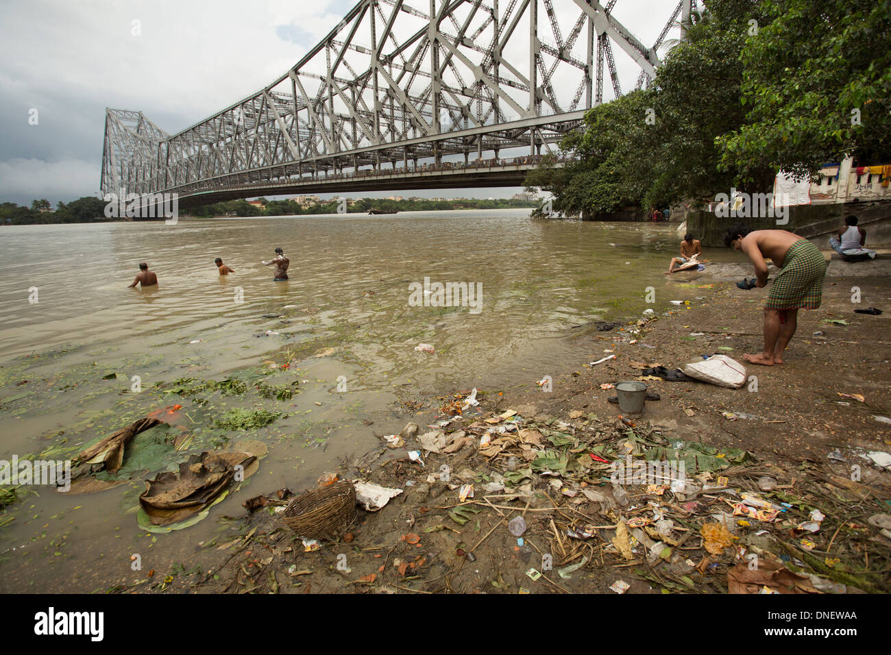 People bathing near the Howrah Bridge - Calcutta (Kolkata), India. Stock Photo