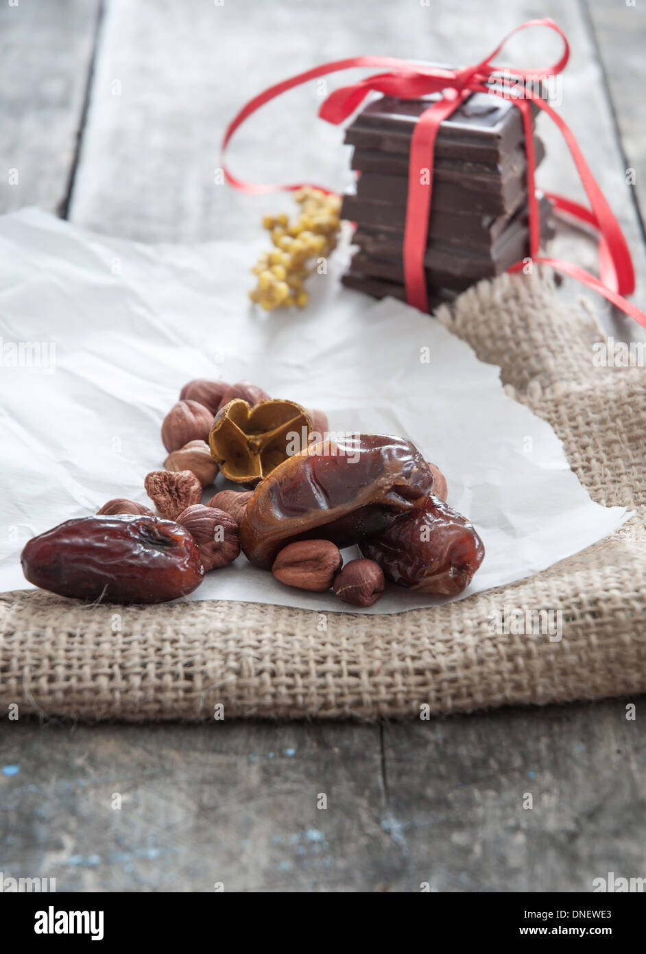Delicious dates and chocolate on wooden surface Stock Photo